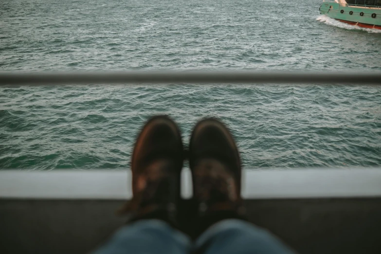 there is a person sitting on the edge of a boat