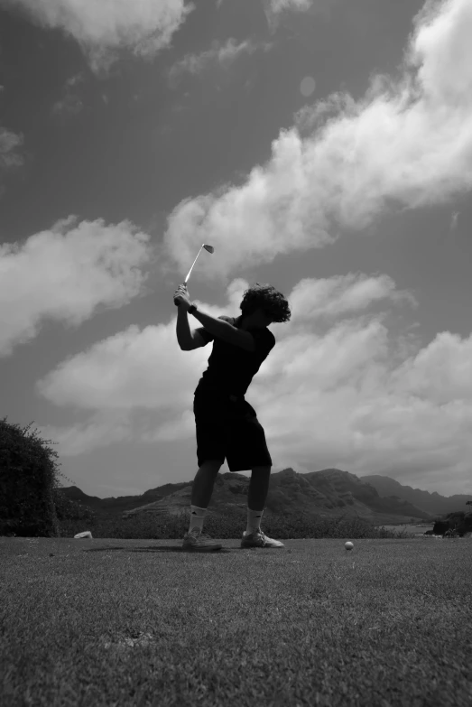 a man is swinging at a ball with a bat