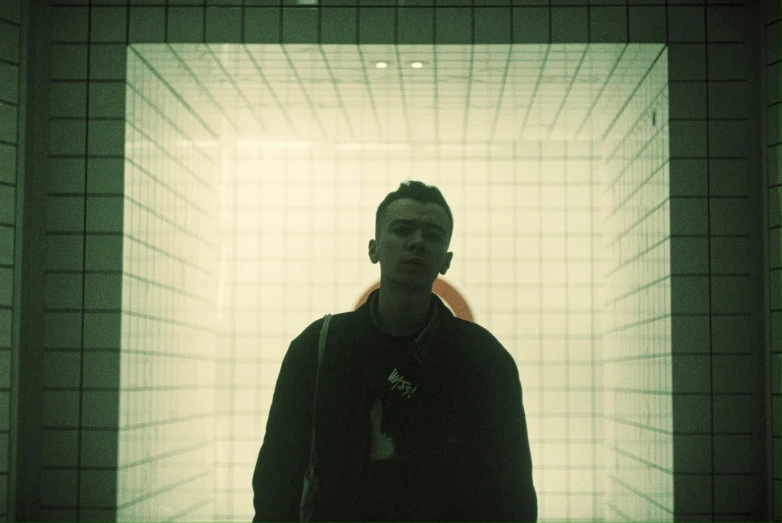 a man standing in a room that has lots of square patterns on it