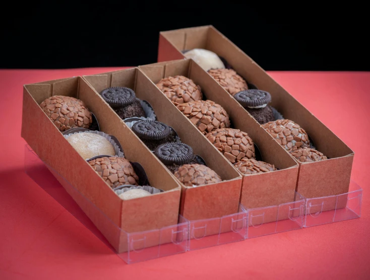 a brown paper box holding different types of cookies