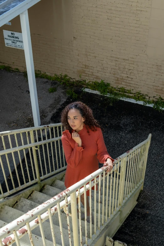 a woman standing at the bottom of stairs