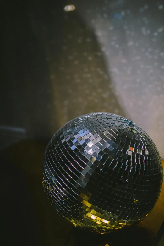 a disco ball sits alone in the dark