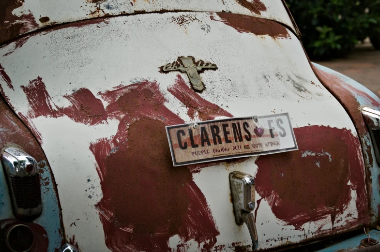 a vintage car painted red and white with rust