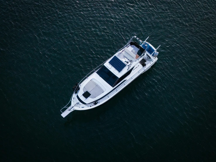 small motorboat sailing down the ocean with people on it