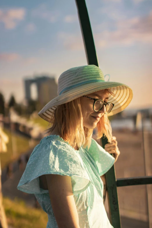 the woman is wearing a hat while holding onto her phone