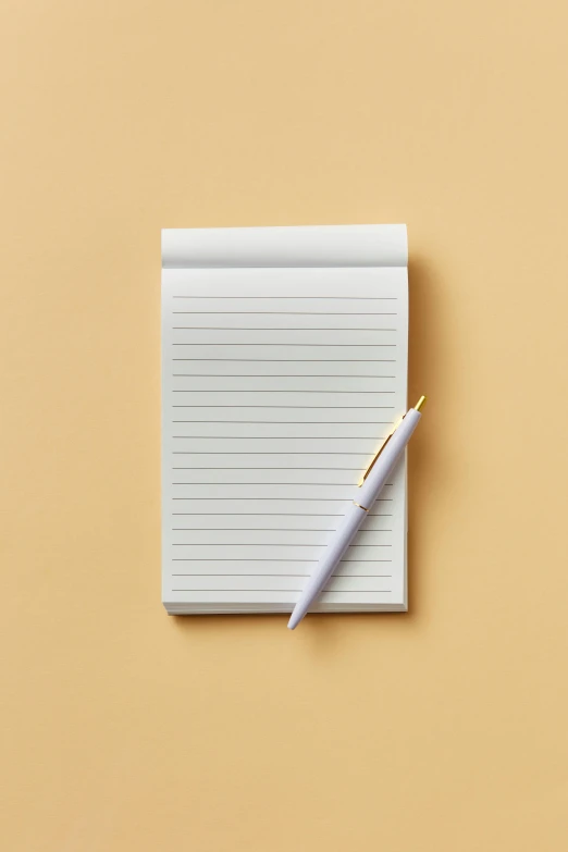 a note pad with a small yellow pen attached