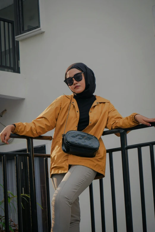 a woman standing on top of a black railing