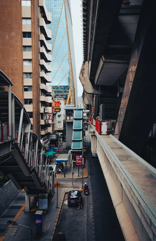 some buildings and chairs are all next to a bridge