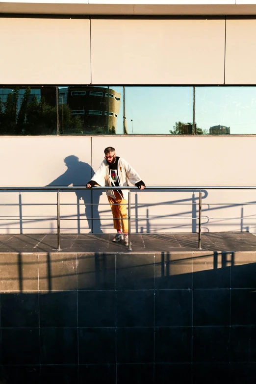 a man on a skateboard rides down the rail