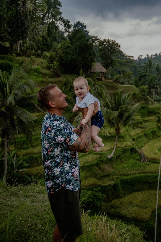 a man is holding up a young child