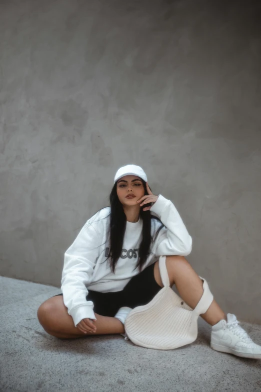 a woman with long hair wearing a white jacket and hat