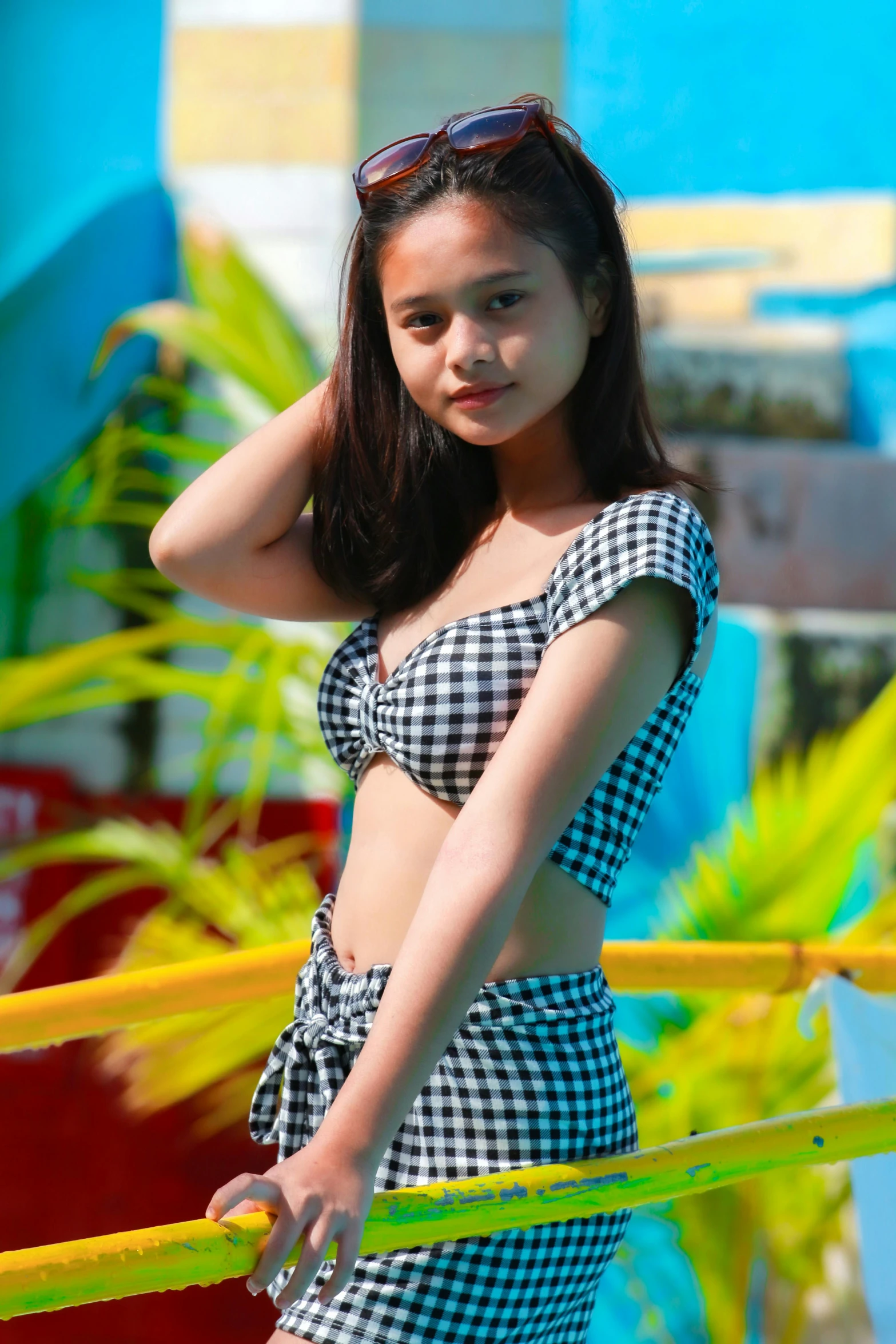 a pretty young lady wearing a bikini top