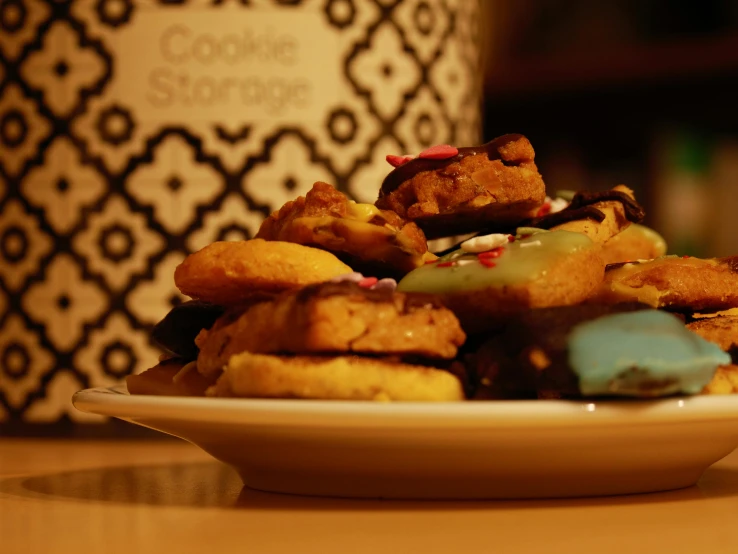 small desserts on a white plate with cup behind