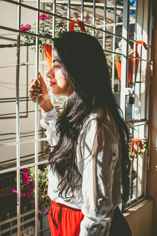 a woman looking out a window of a building