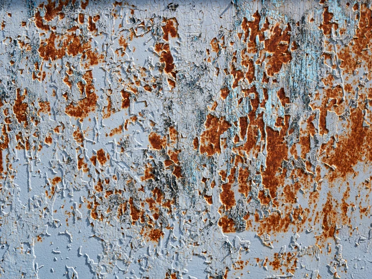 a piece of red metal and white paint with chippings on it