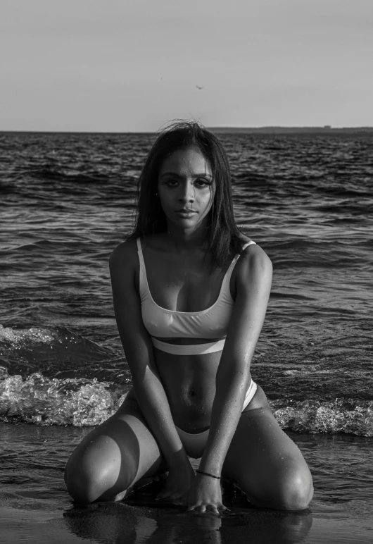 woman in white bikini sitting in water