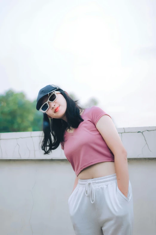 a woman wearing shades and wearing pink shirt