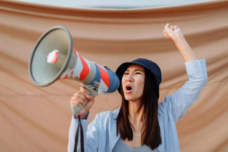 the girl is yelling into a megaphone