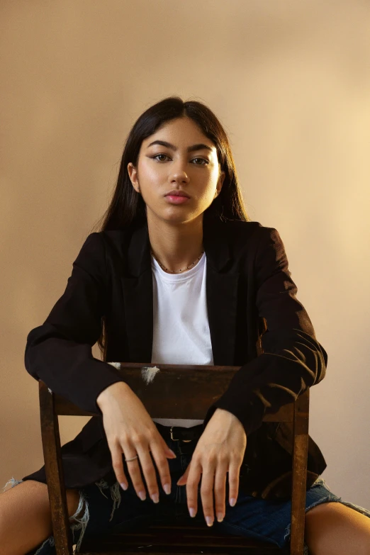 a woman sitting in a chair posing for a picture