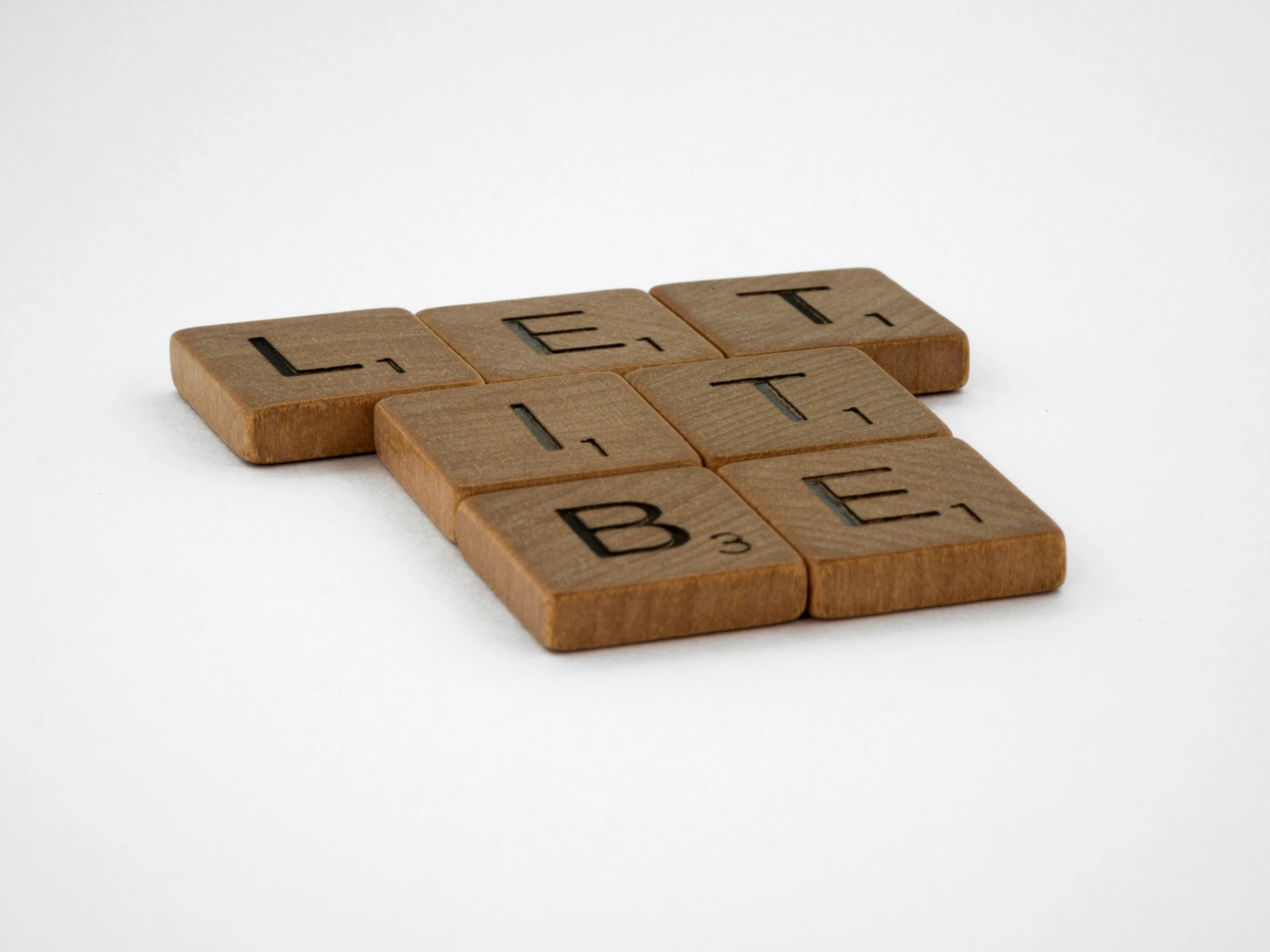 three pieces of wooden are shown arranged to look like letters