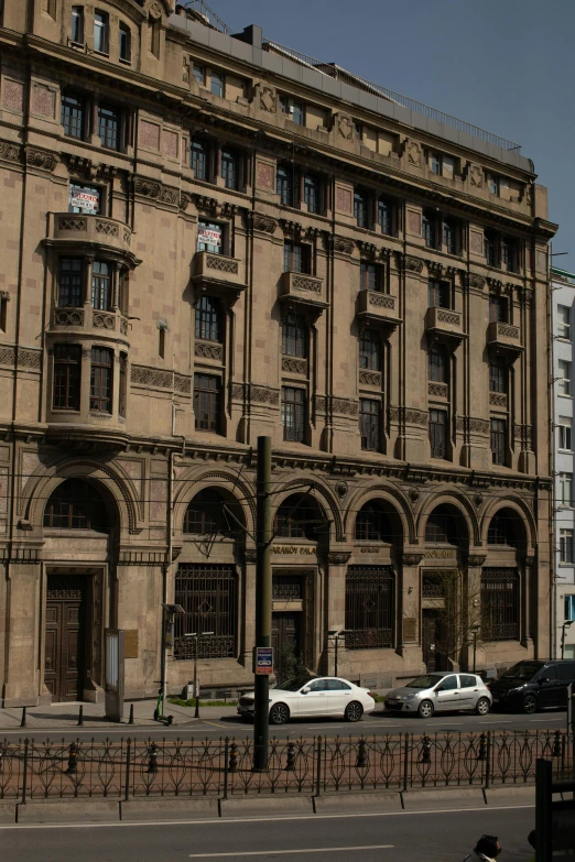 cars are parked on the street near a building