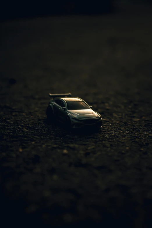 a dark image of a toy car in the middle of the road