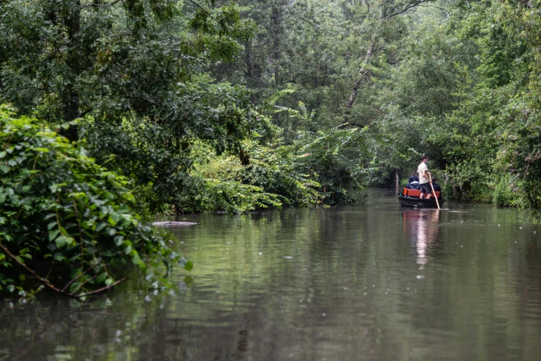 a person in a boat going down the canal