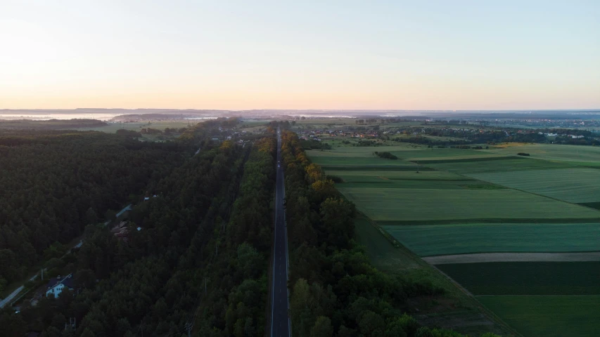 an aerial view of a green field with lots of trees