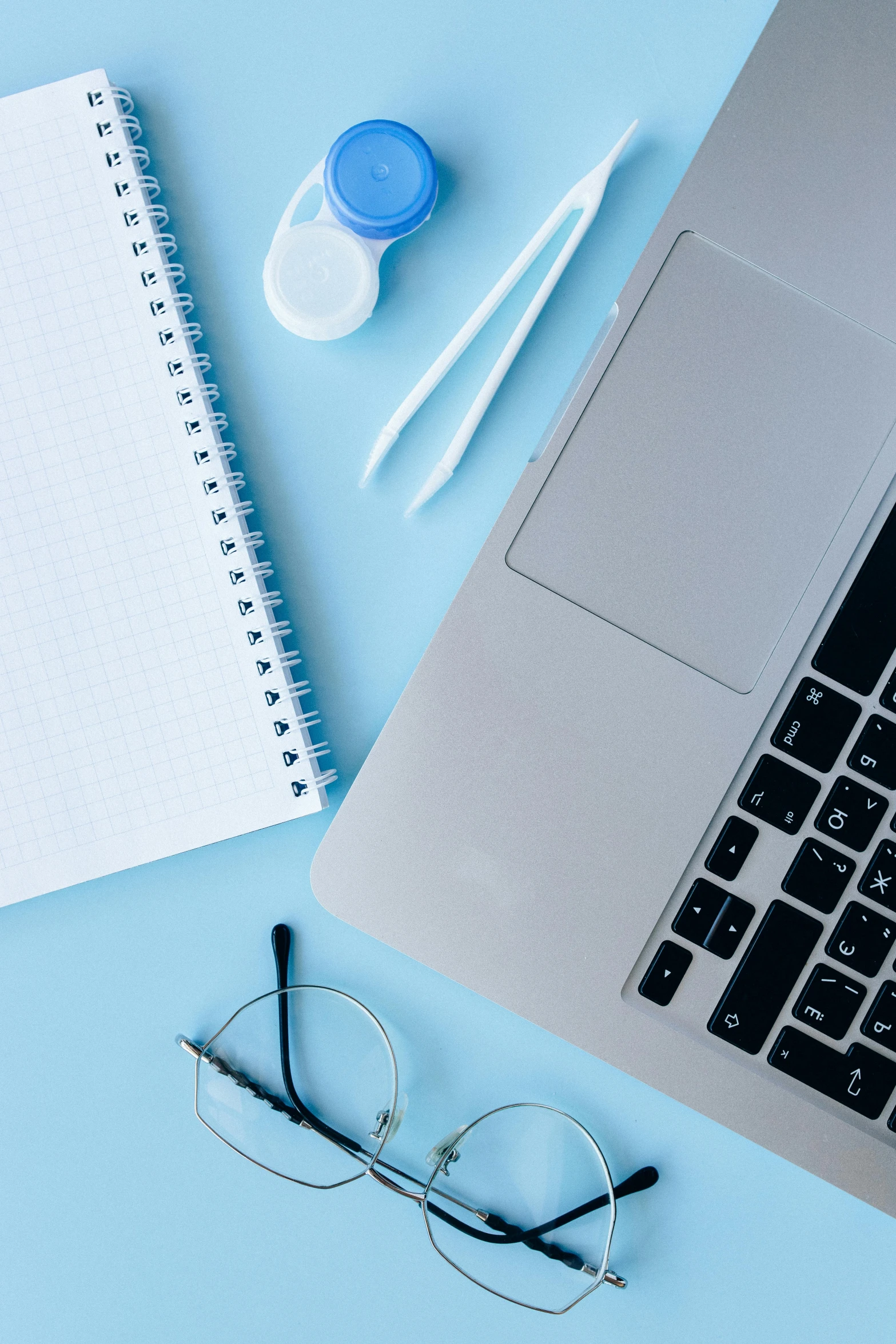 a laptop and some glasses on a desk