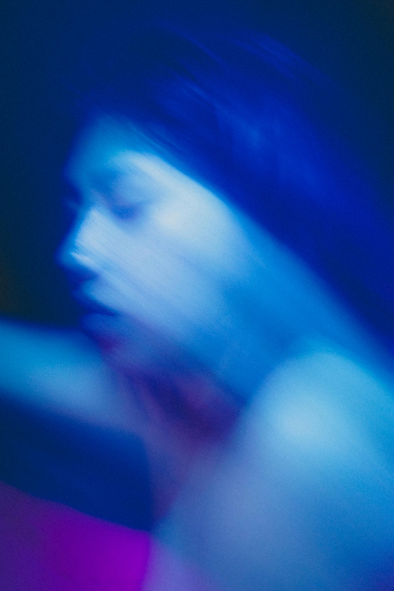 blurry blue image of a man with  on