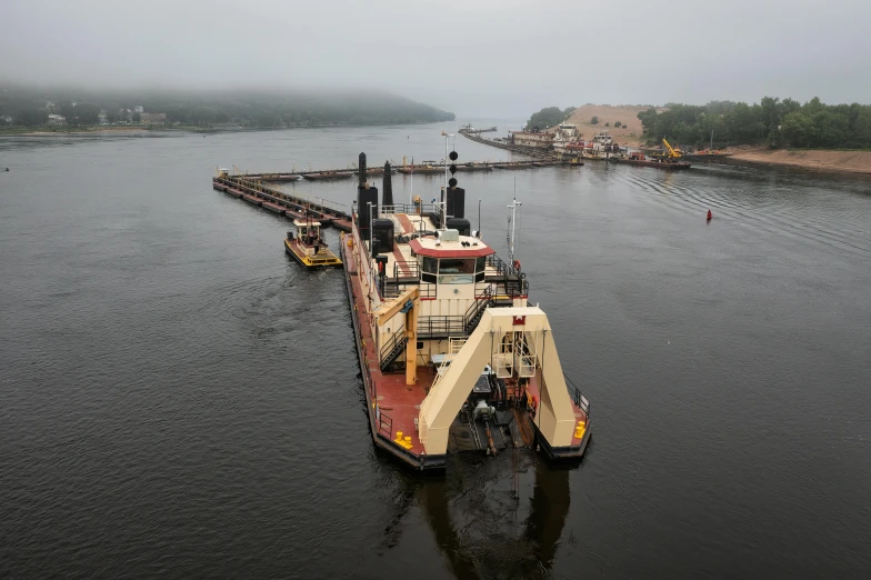 a large boat being loaded with machinery out on the water