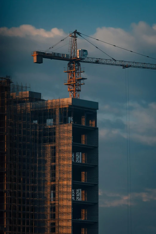 a big tower crane on top of a tall building