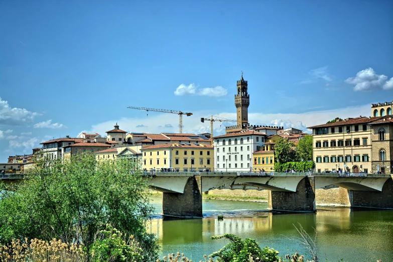 a large bridge with old buildings on the other side