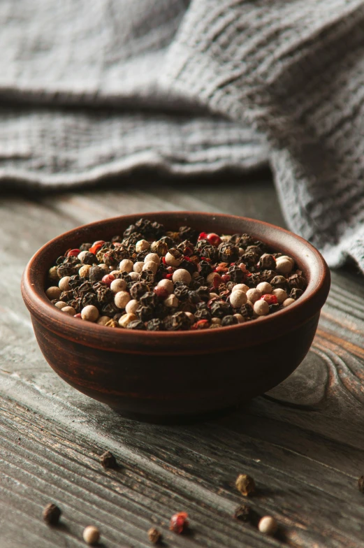 a bowl full of ground beans on a wooden table