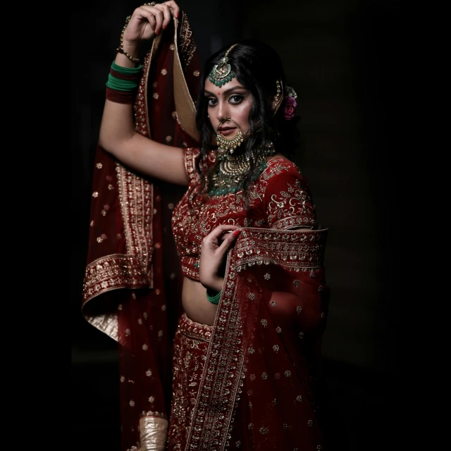 a beautiful woman in red dress with a veil