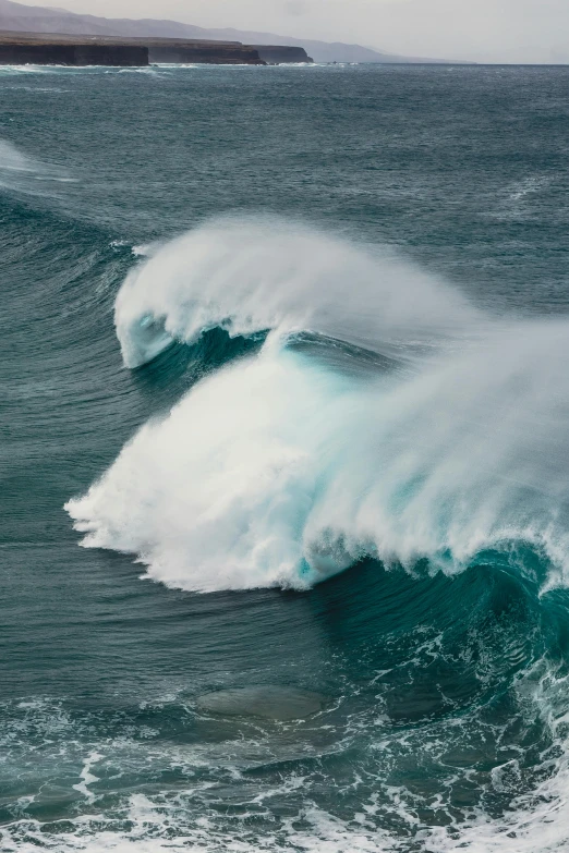 a large wave breaking into the water