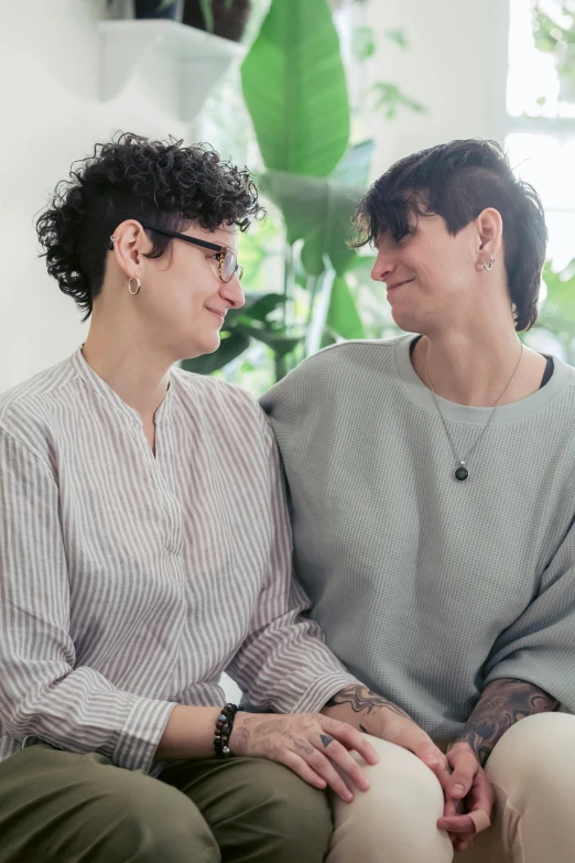 two women sitting together smiling for the camera