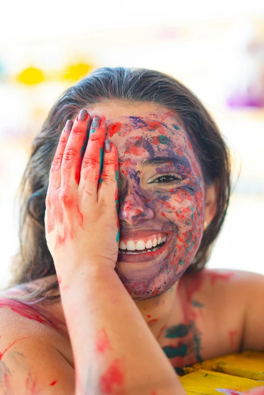 a woman covered in powder smiles for the camera