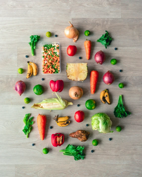 an assortment of different fruits and vegetables arranged in the shape of a heart