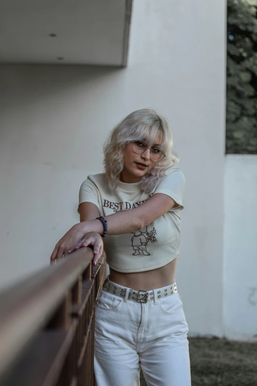 a woman in crop tops posing on a balcony