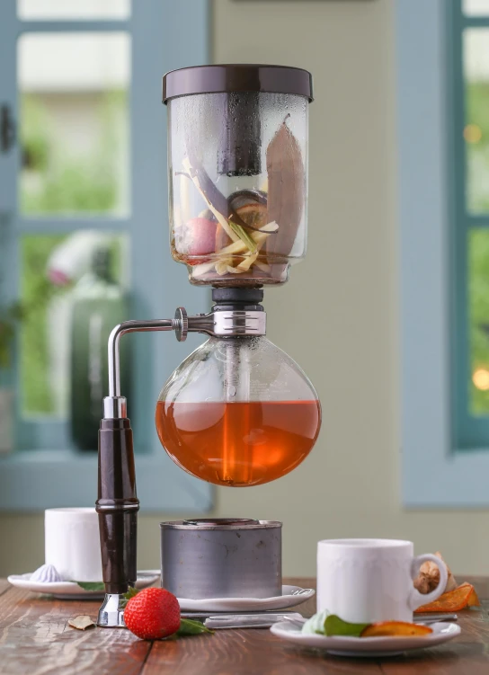 a blender full of liquid on top of a table