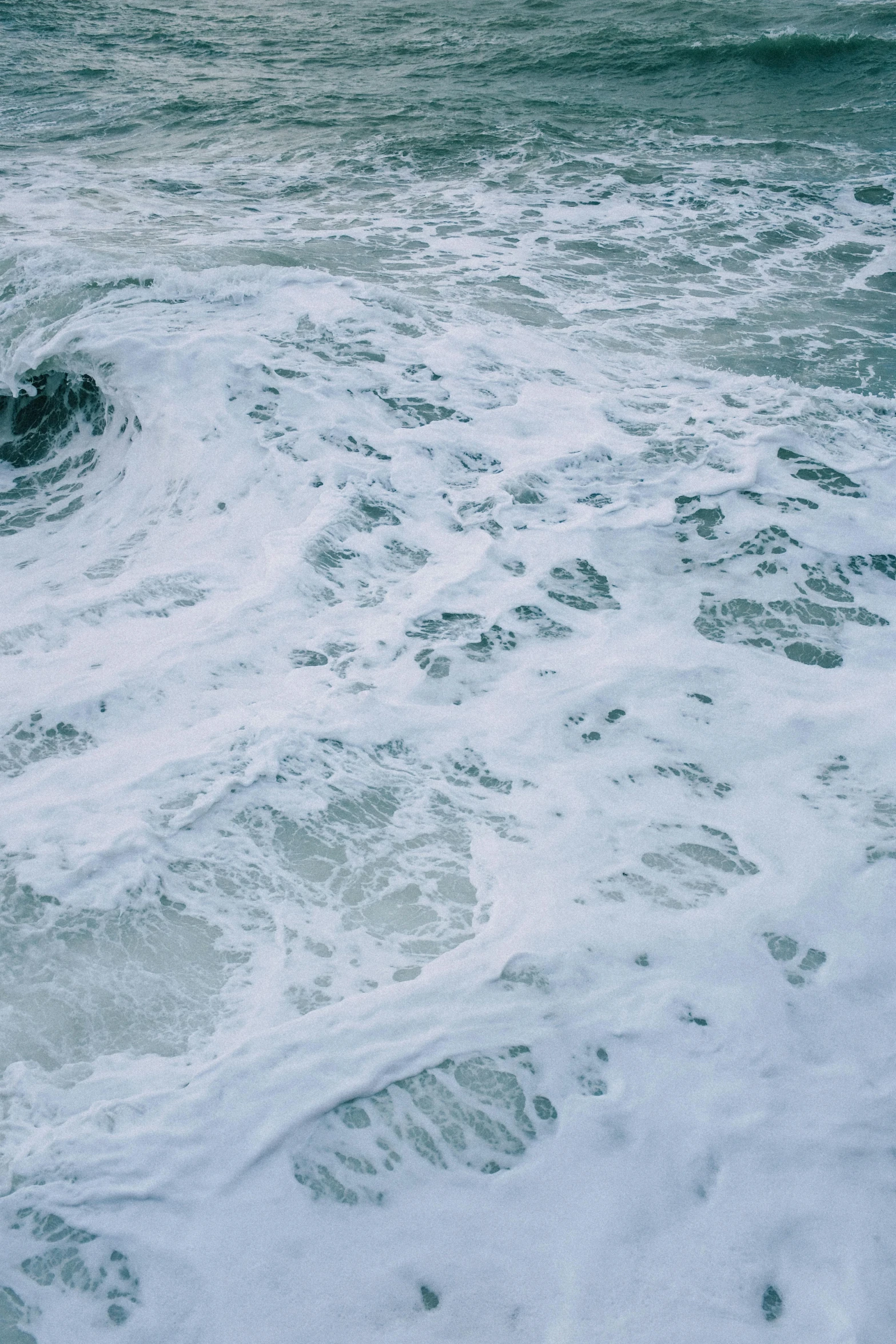 view from a beach as waves wash up on it