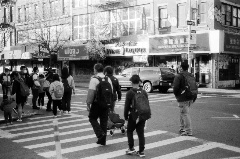 a group of people walking across a street