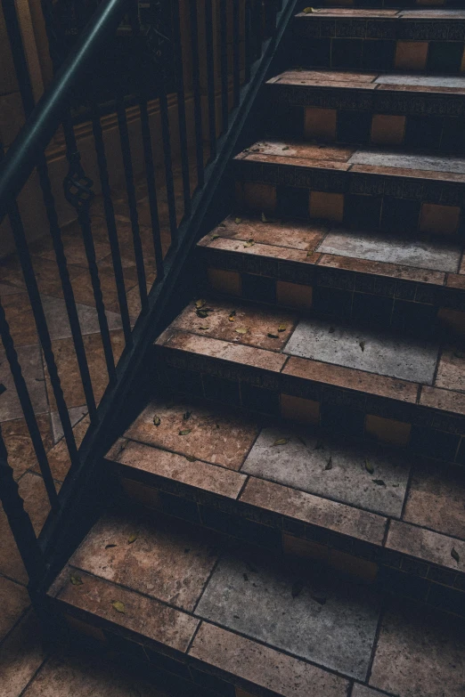 a black hand rail and steps leading to an upper floor