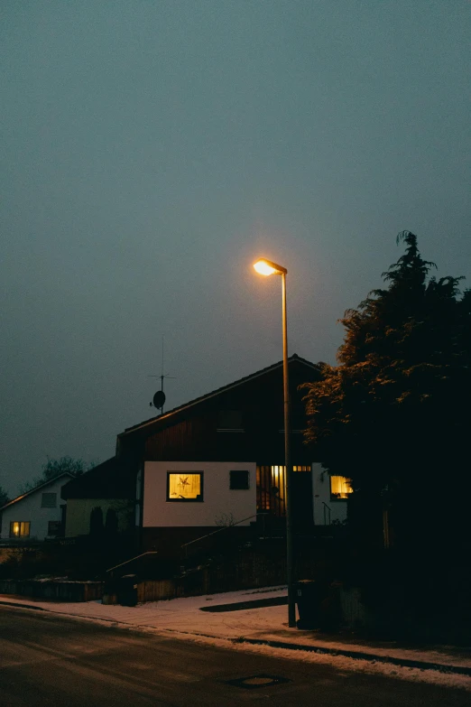 the view of a house and street lights at night