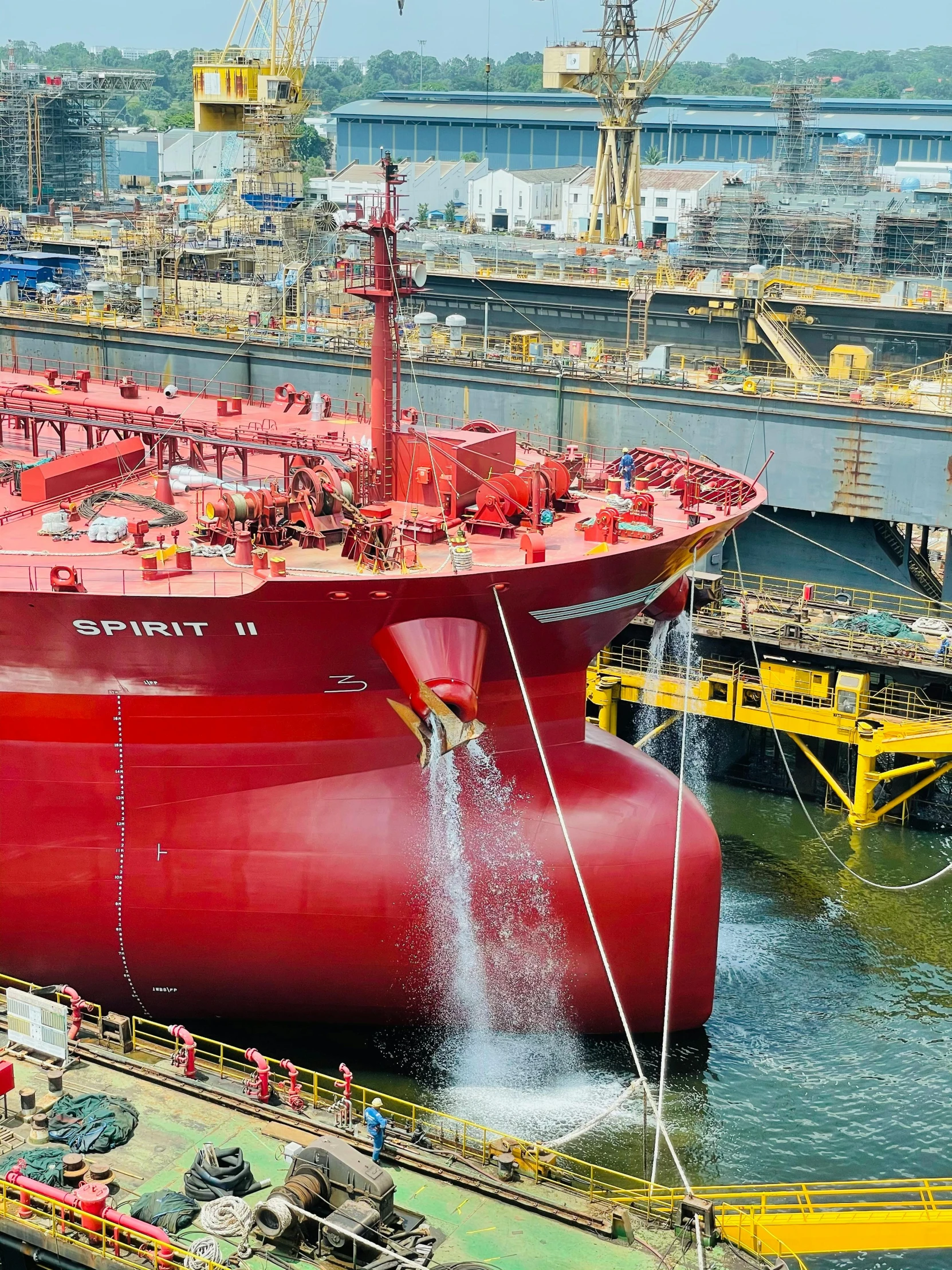 a huge red ship with water pouring from it