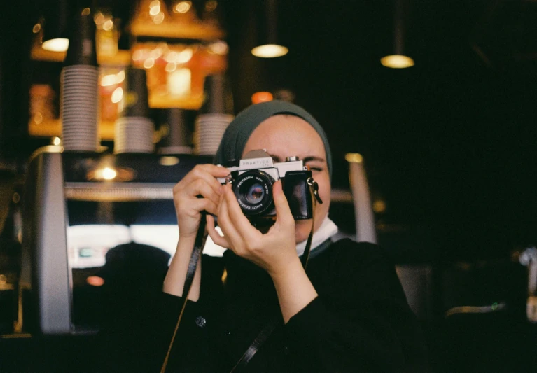 a person taking a picture with an old style camera