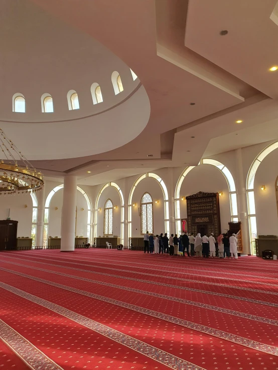 inside of a large room with many windows and rugs