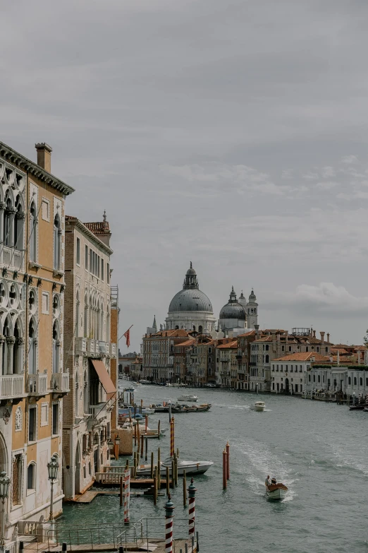 a boat travels down a canal past buildings in venice