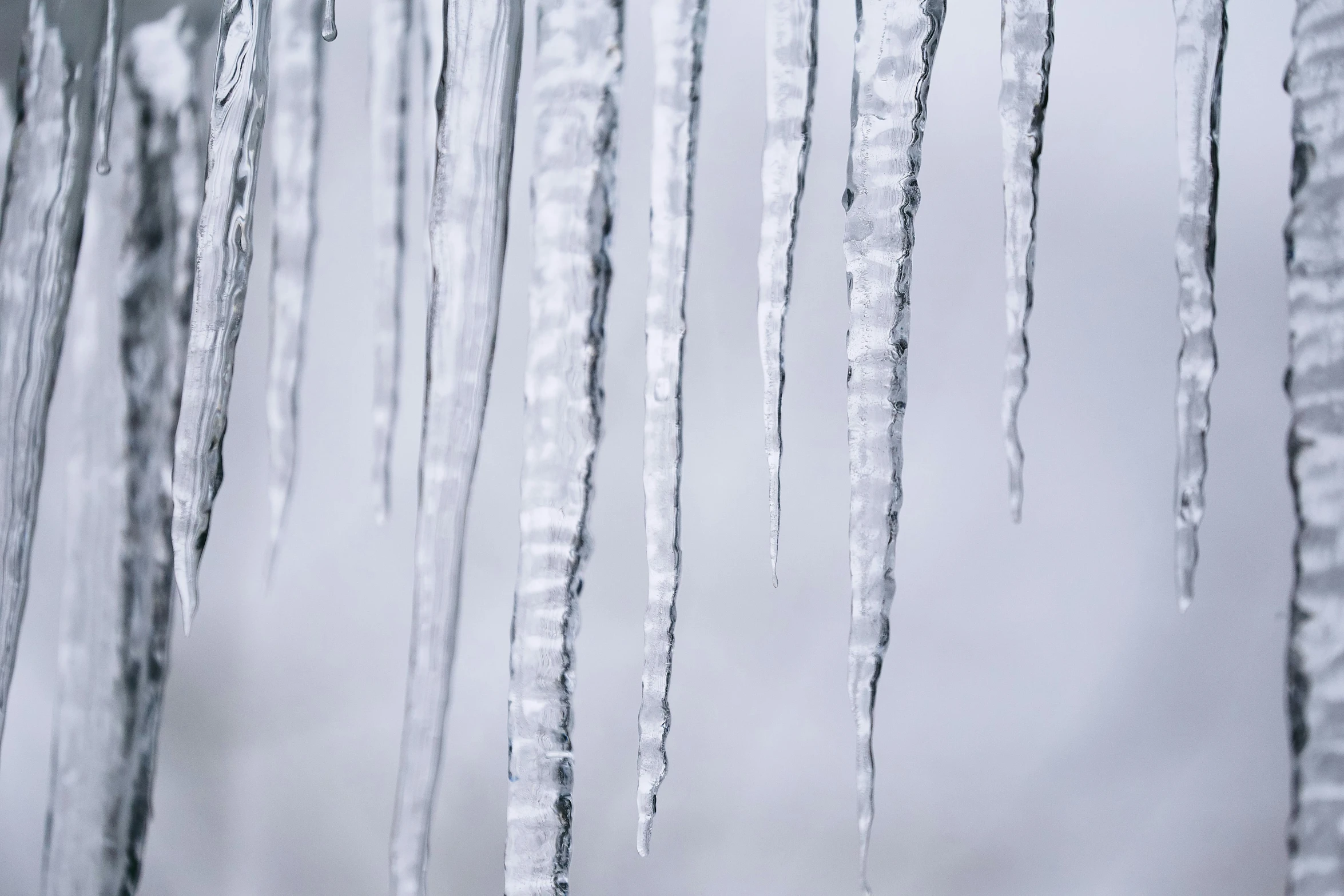 frosty icicles hanging from the side of a building